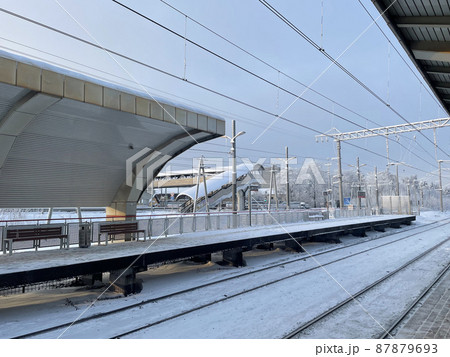 Empty railway platform without passengers in winter at the sunset. Empty railway platform without passengers in winter at the sunset. 87879693