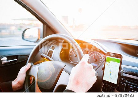 Gps device map system. Global positioning system on smartphone screen in auto car on travel road. GPS vehicle navigator driver device. 87880432