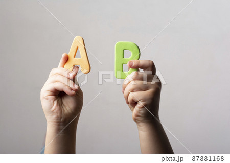 Hands holding two spongy alphabet AB letters 87881168