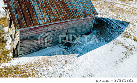 Collapsing red buiilding in winter 87881835