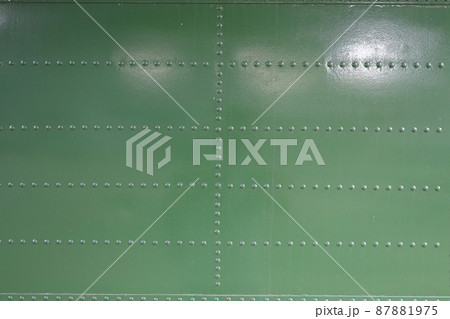 close up of Metal surface of the aircraft fuselage with rivets, Rivets on green or gray metal. 87881975