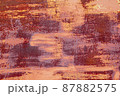 Red brown abstract  background with pink hues. A weathered, rust-eaten textured sheet of metal with traces of paint residue. 87882575