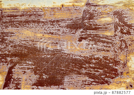 Red brown abstract background with pink and turquoise hues. A weathered, rust-eaten textured sheet of metal with traces of paint residue. Red brown abstract background with pink and turquoise hues. A weathered, rust-eaten textured sheet of metal with traces of paint residue. 87882577