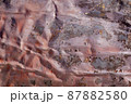 Dark pink abstract background with silver grey brown red and purple hues. A weathered, rust-eaten, crumpled textured sheet of metal. 87882580