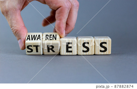 Stress awareness symbol. Businessman turns cubes and changes the word 'stress' to 'awareness'. Beautiful grey background. Business, psychological and stress awareness concept. Copy space. 87882874