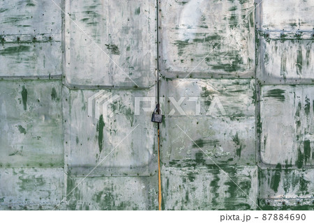 Old doors of the locked garage. Old doors of the locked garage. 87884690