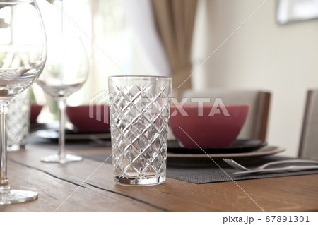 Elegant table set up for dinning room with red and black plate at home Elegant table set up for dinning room with red and black plate at home 87891301