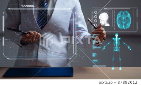 Woman doctor reviewing a human anatomy on head up display Woman doctor reviewing a human anatomy on head up display 87892012