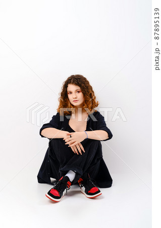 Cute girl sitting in studio on the floor 87895139