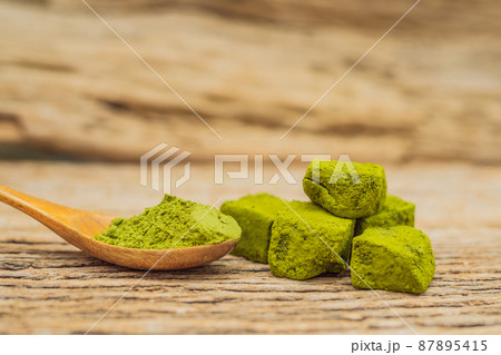 Matcha powder and candy made of matcha on wooden background. Homemade Matcha 87895415