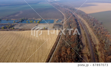 Panoramic Moving Freight Train Along Railway Tracks, Trees Agricultural Fields Panoramic Moving Freight Train Along Railway Tracks, Trees Agricultural Fields 87897073
