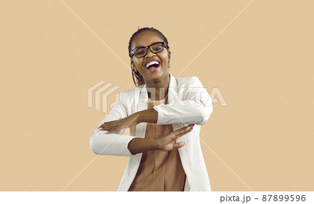 Overjoyed young African American woman isolated on pink studio background dancing and laughing. Happy millennial black girl in glasses have fun make dancer moves, celebrate success. Overjoyed young African American woman isolated on pink studio background dancing and laughing. Happy millennial black girl in glasses have fun make dancer moves, celebrate success. 87899596