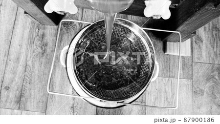 Drop of bee honey drip from hexagonal honeycombs Drop of bee honey drip from hexagonal honeycombs 87900186