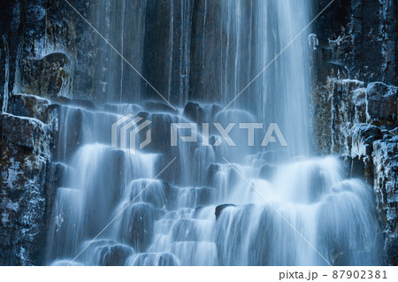 Long exposure of waterfall over the icy wall Long exposure of waterfall over the icy wall 87902381
