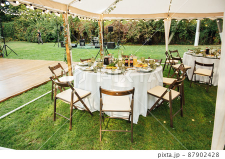 Wedding. Banquet. The chairs and round table for guests, served with cutlery. 87902428