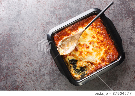 Portuguese casserole Bacalhau espiritual delicious cod cooked with onion, grated carrots sprinkled with grated cheese closeup. Horizontal top view 87904577