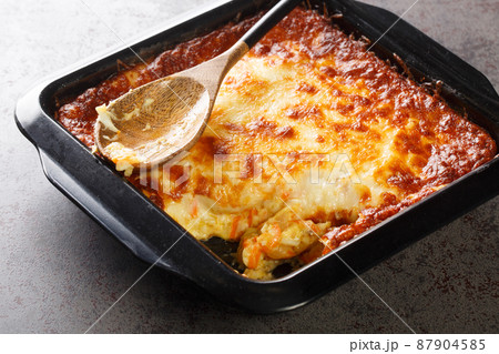 Spiritual Cod is a Portuguese casserole made of salt cod, carrot, bread, Bechamel sauce and topped with cheese closeup. Horizontal 87904585