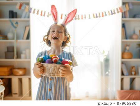 child with Easter painting eggs 87906830