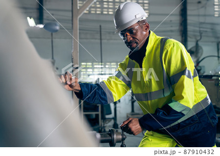 Factory worker or engineer do machine job in adept manufacturing workshop 87910432