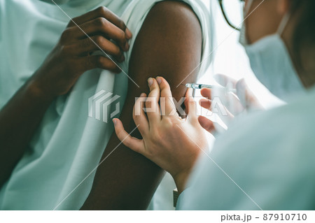 Young man visits skillful doctor at hospital for vaccination Young man visits skillful doctor at hospital for vaccination 87910710