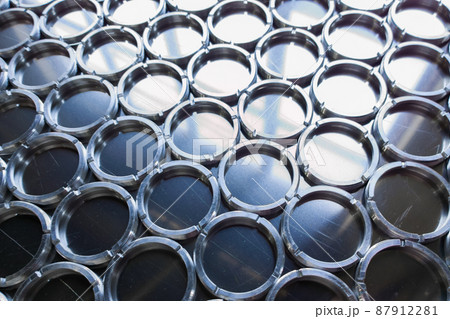 shiny metal rings after turning and milling, silver colored parts on flat steel surface close-up full frame background shiny metal rings after turning and milling, silver colored parts on flat steel surface close-up full frame background 87912281