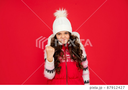 portrait of child wearing warm clothes. express emotion. winter fashion. angry aggressive kid portrait of child wearing warm clothes. express emotion. winter fashion. angry aggressive kid 87912427