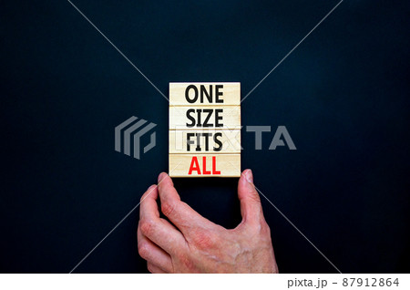 One size fits all symbol. Concept words One size fits all on wooden blocks. Businessman hand. Beautiful black table black background. One size fits all business concept. Copy space. 87912864