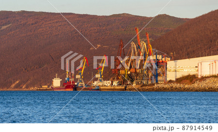 Morning view of the cargo seaport and mountains Morning view of the cargo seaport and mountains 87914549