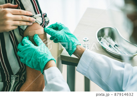 Young woman visits skillful doctor at hospital for vaccination Young woman visits skillful doctor at hospital for vaccination 87914632