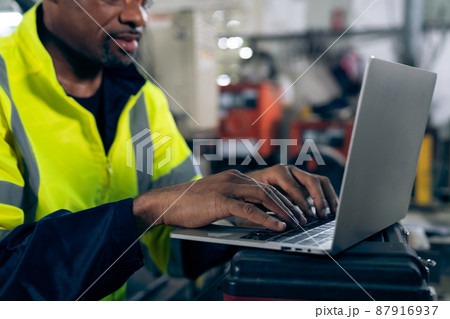 Factory worker working with laptop computer to do adept procedure checklist 87916937
