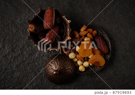 Dates and nut mix at stone background. 87919693