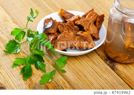 Marinated saffron milk cap mushrooms with fresh greens 87919962