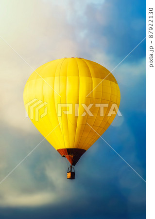 Yellow hot air balloon in blue sky 87922130