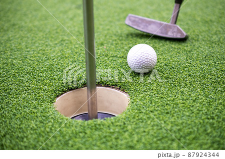 Golf ball and golf club on artificial grass. Golf ball and golf club on artificial grass. 87924344