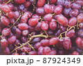 Bunch of colorful grapes with leaves 87924349