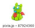 Play plasticine Dragon on white background. Handmade clay plasticine 87924360