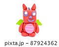 Play plasticine Dragon on white background. Handmade clay plasticine 87924362