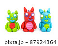 Play plasticine Dragon on white background. Handmade clay plasticine 87924364