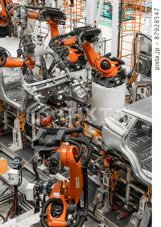 Vertical photo of automobile production line. Modern car assembly plant. Auto industry. Interior of 87928547
