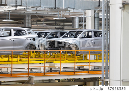 Photo of automobile production line. Modern car assembly plant. Modern and high-tech automotive Photo of automobile production line. Modern car assembly plant. Modern and high-tech automotive 87928586
