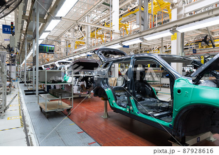 Photo of automobile production line. Welding car body. Modern car assembly plant. Auto industry Photo of automobile production line. Welding car body. Modern car assembly plant. Auto industry 87928616