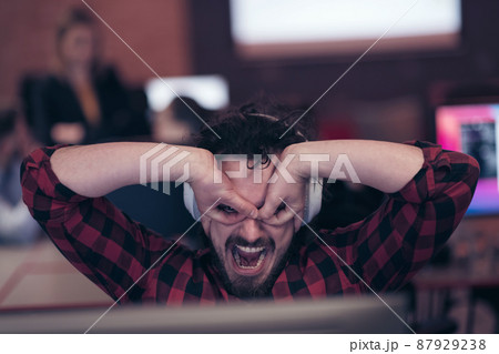 Funny businessman wearing headset having virtual team meeting group call chatting with diverse people in customer support. Video conference call on computer with manager and employees. 87929238