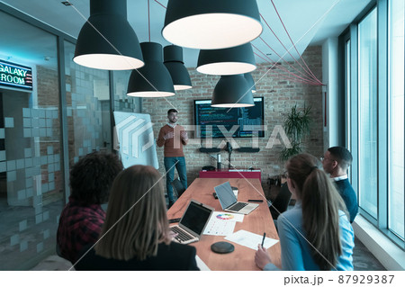 Leader give a business presentation at an office conference meeting, businessman coach mentor explains graph chart on board corporate group workshop training in boardroom. Selective focus  87929387