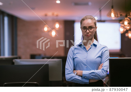Portrait of freelancer standing in co-working space. Confident businesswoman looking at camera. 87930047