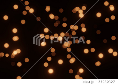 Defocused bokeh lights on black background, an abstract naturally blurred backdrop for Christmas eve or birthday party. Festive light texture. Yellow and red garland in blur. Overlay effect for design Defocused bokeh lights on black background, an abstract naturally blurred backdrop for Christmas eve or birthday party. Festive light texture. Yellow and red garland in blur. Overlay effect for design 87930327
