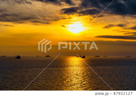 Beautiful sunset in the sea and ships. The sun shines through the clouds and is reflected in the waves Beautiful sunset in the sea and ships. The sun shines through the clouds and is reflected in the waves 87932127