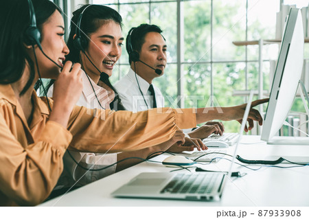 Business people wearing headset working actively in office 87933908