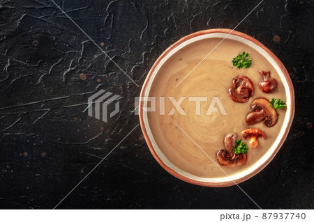 Mushroom soup in a rustic bowl, overhead shot...の写真素材