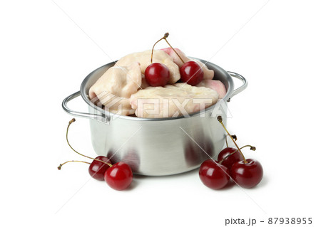 Pot with pierogi with cherry isolated on white background Pot with pierogi with cherry isolated on white background 87938955