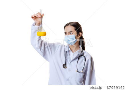 Portrait of young woman, doctor, therapeutic or medical advisor wearing face mask and white uniform isolated on white background. Health care concept 87939162